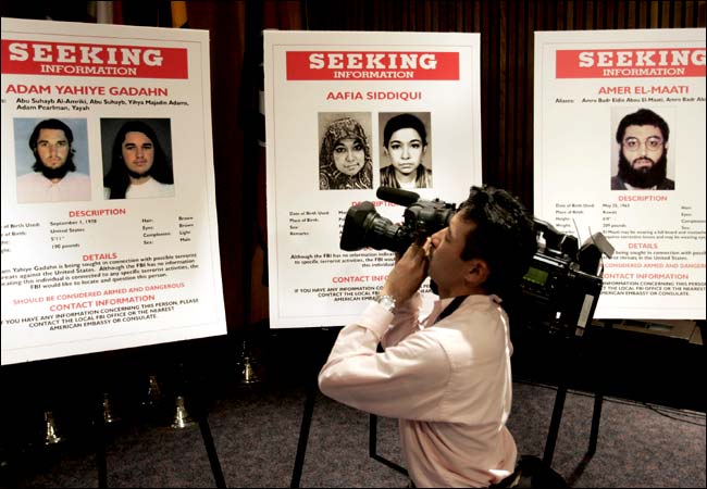 Before the start of a news conference at F.B.I. headquarters, a cameraman photographed placards of suspects, May 26, 2004.